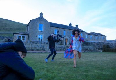 Melanie Brown running from the house in the Love Should Not Hurt music video, being filmed on set