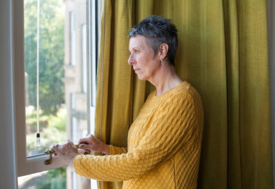 Older woman looking out of the window